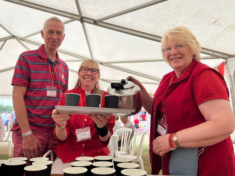 Photo showing 3 people smiling and serving drinks. One is the Minister of Ashbourne Methodist Church and Circuit