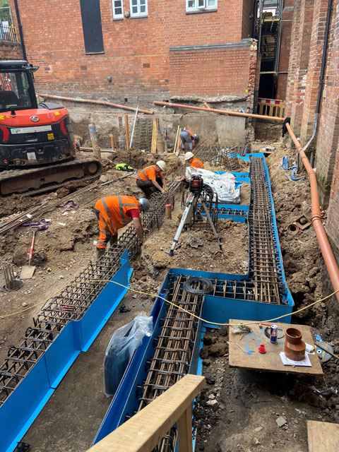 Work on the foundations for the new Link foyer is continuing. Here the steel work and shuttering for the beams which sit on the piles is being installed. These big foundations are needed both to support the new building and to keep the surrounding structures secure