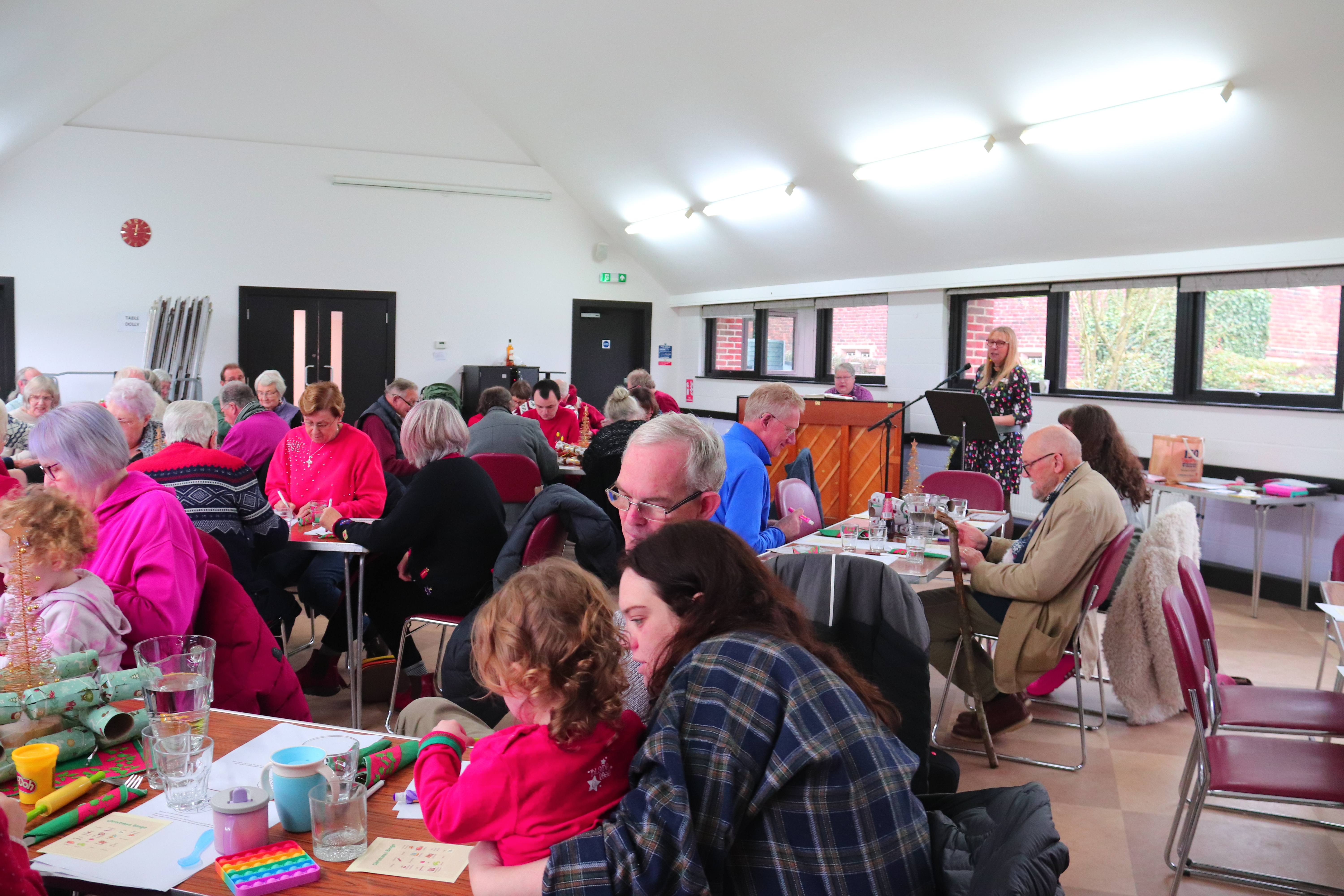 A photo of a church hall full of people sat at tables