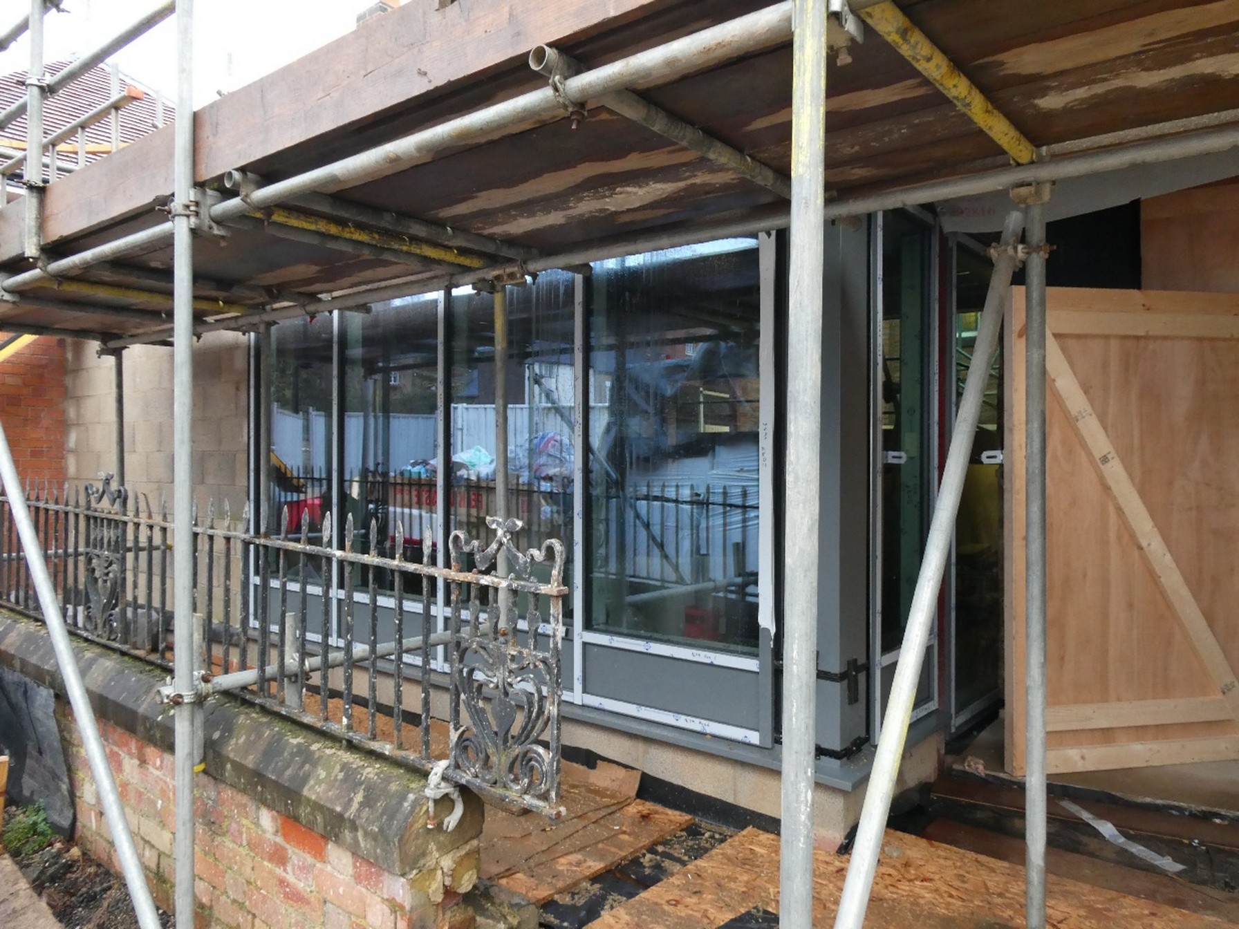 The front window glass in the Link foyer is installed 