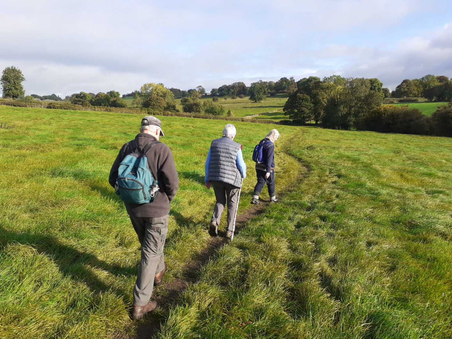 A photo of walkers at the top of a hill