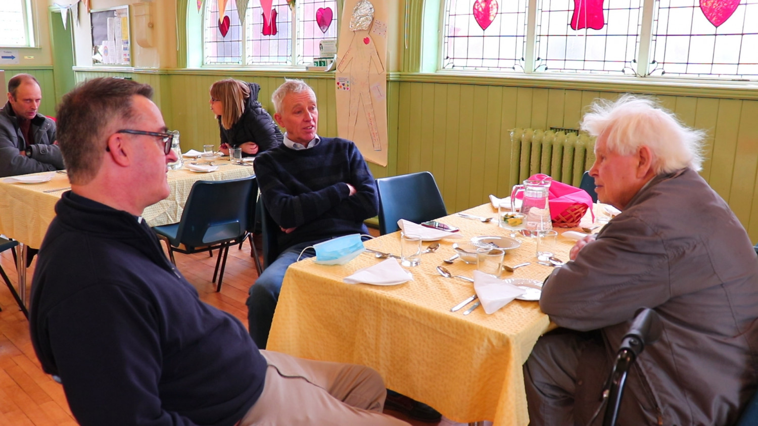 Photo of people sat at a table chatting