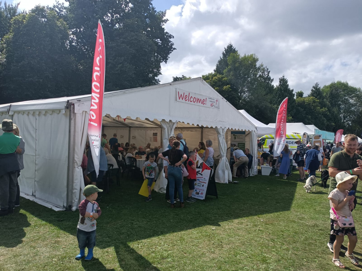 Photo showing the inside of a marquee full of people sat at tables enjoying refreshments