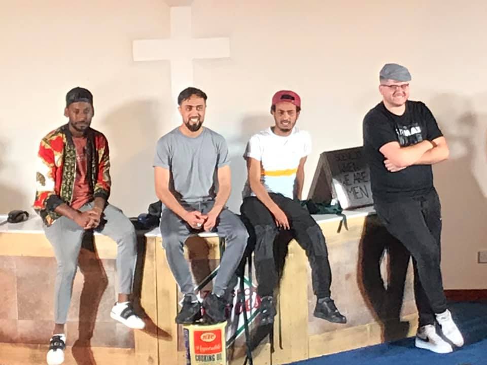 Photo showing four actors from Pizza Shop Heroes on stage at Ashbourne Methodist Church